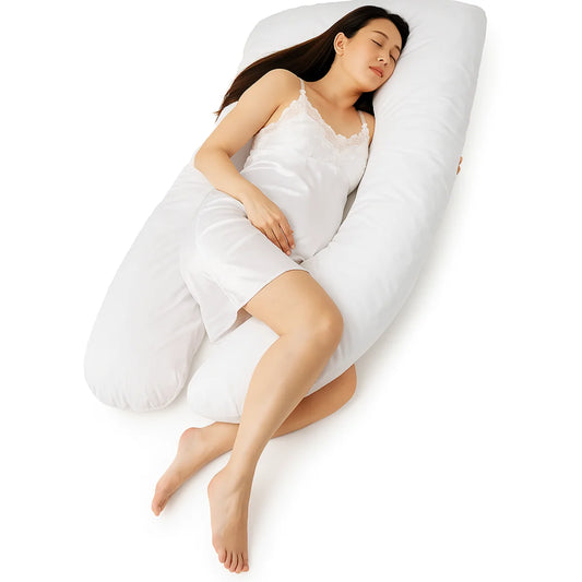 Woman sleeping on a large U-shaped pillow against a white background