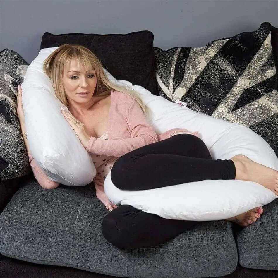 Sanggol | Woman sleeping in a J shaped Body Pillow on a Sofa